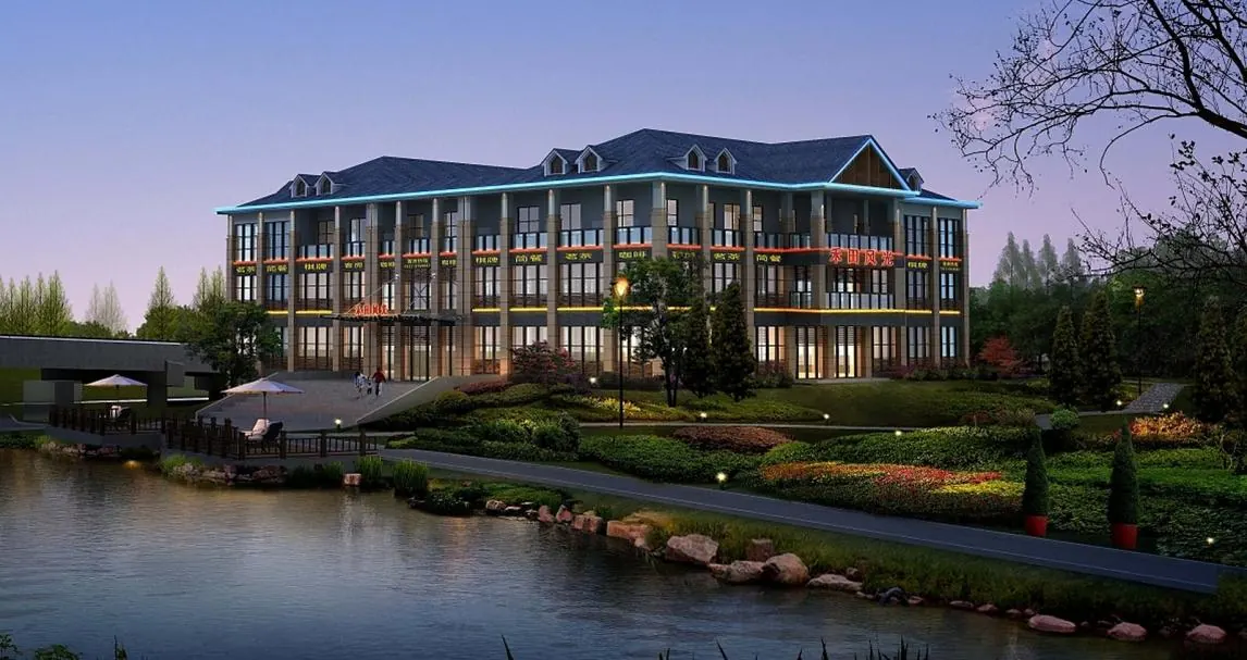Evening view of the Hetian Fengguang residential development beside landscaped water.